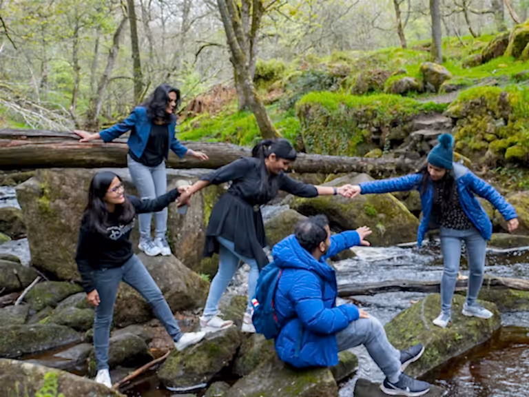 Family enjoying stepping stones in Peak District